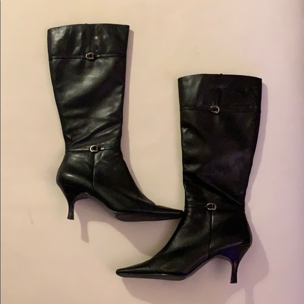 Black thigh high skinny heeled boots.